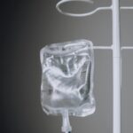 A close-up view of an IV fluid bag hanging on a pole, ideal for healthcare concepts.